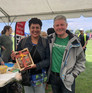 Affirm2 cropped Winners are grinners … Kāinga Ora Area Manager Tim presents Cairo with a Christmas cake after she correctly guessed the number of cotton buds in a jar during the Affirm event.