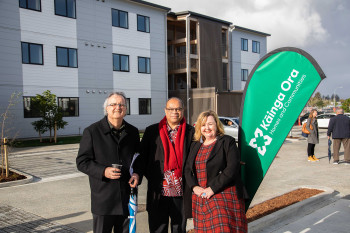Bader McKenzie 7 Three people standing infront of a development