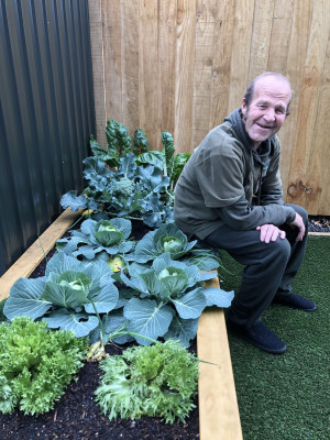 Garden3 Man sitting on a vegetable garden box