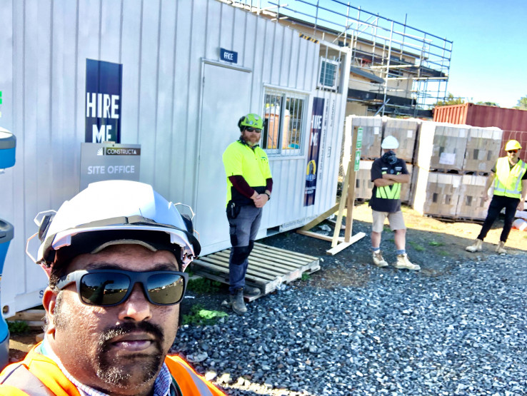 Sites1 Four men standing at a construction site.